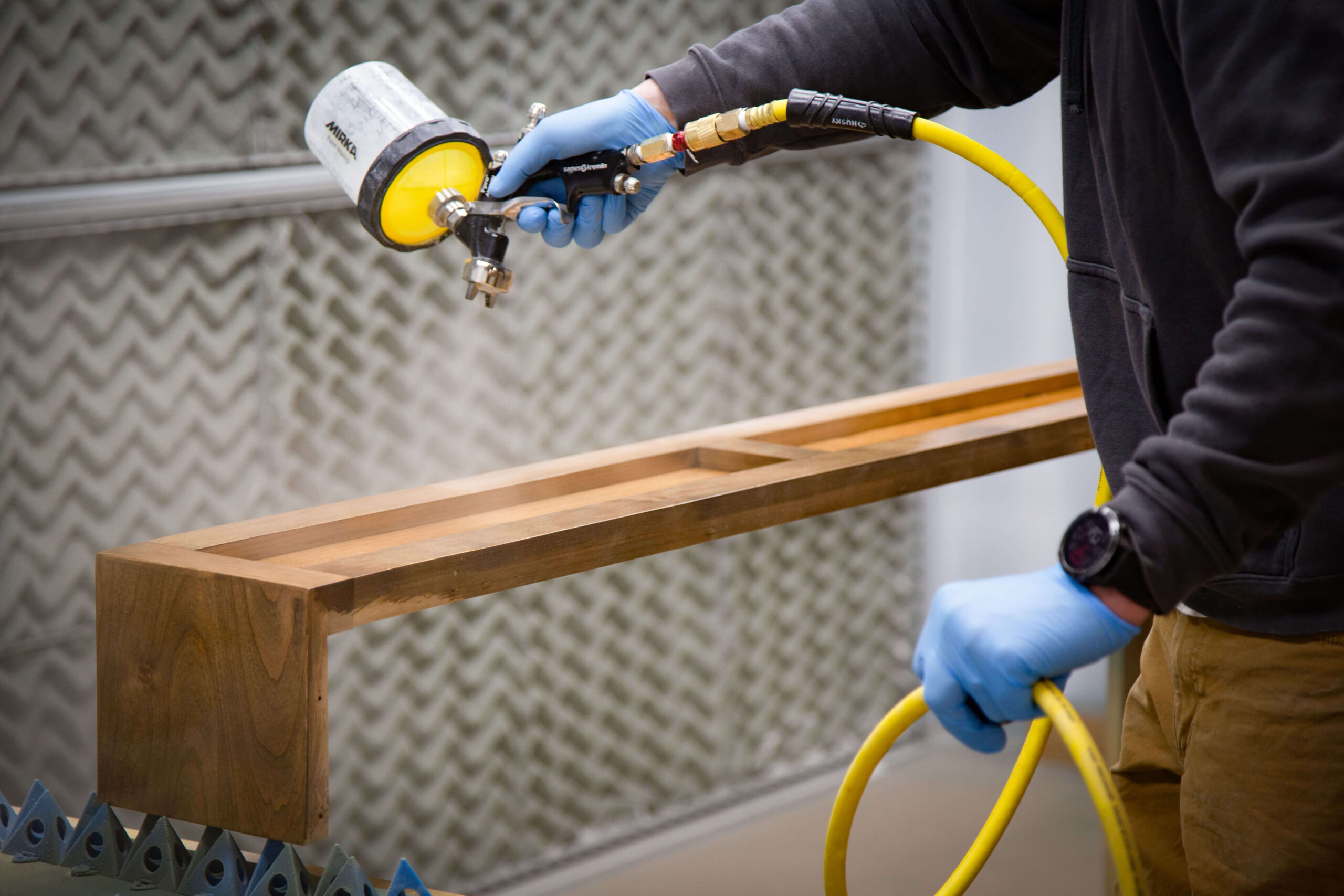 Spraying finish on a cabinet frame