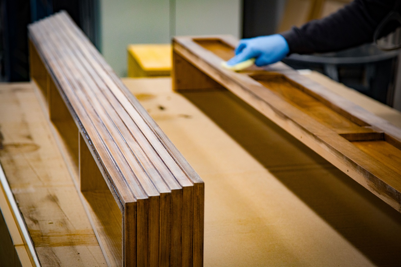 Hand-sanding a cabinet frame in the Sterling shop