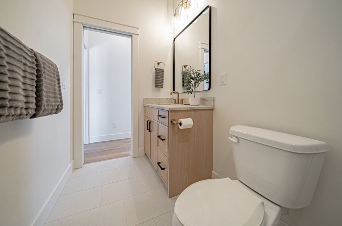 Bathroom vanity in light oak with black hardware