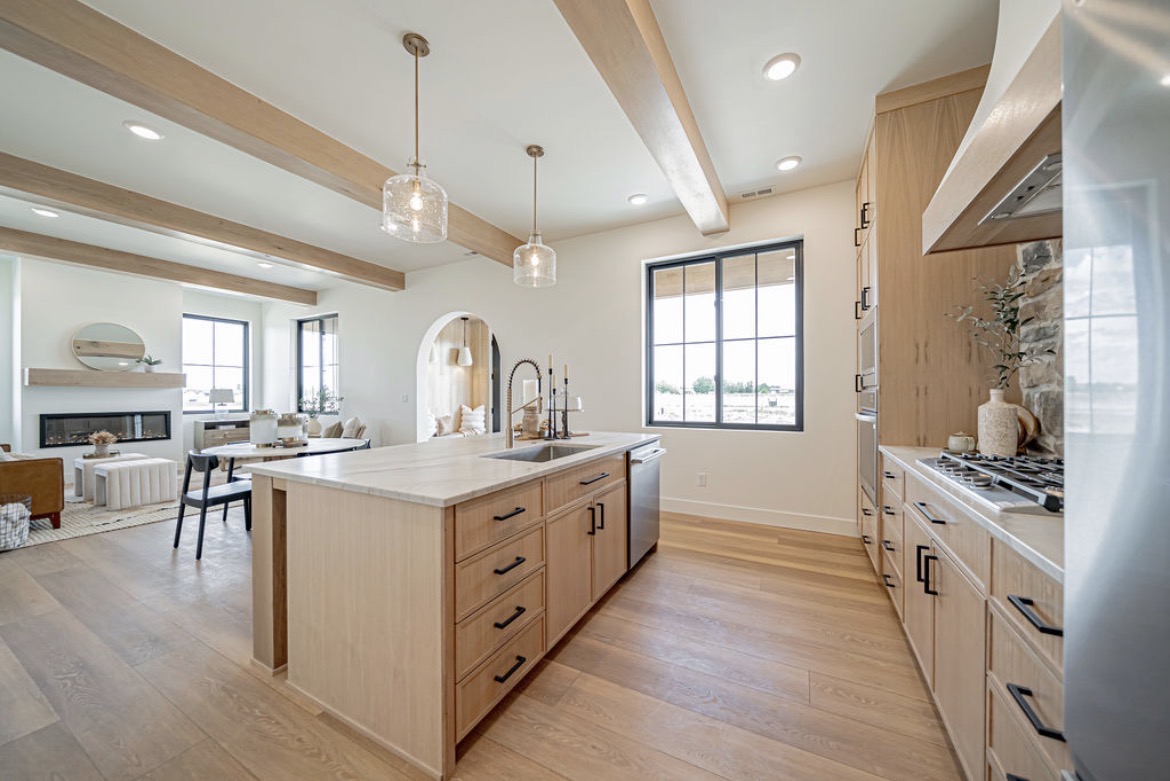 Installed light oak kitchen cabinetry with a large island